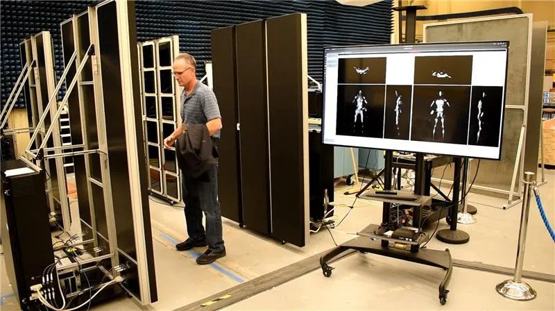 Modular Real-Time panels scan a ‘passenger’ in a laboratory setting. At right is a large monitor displaying scan results from six different angles.
