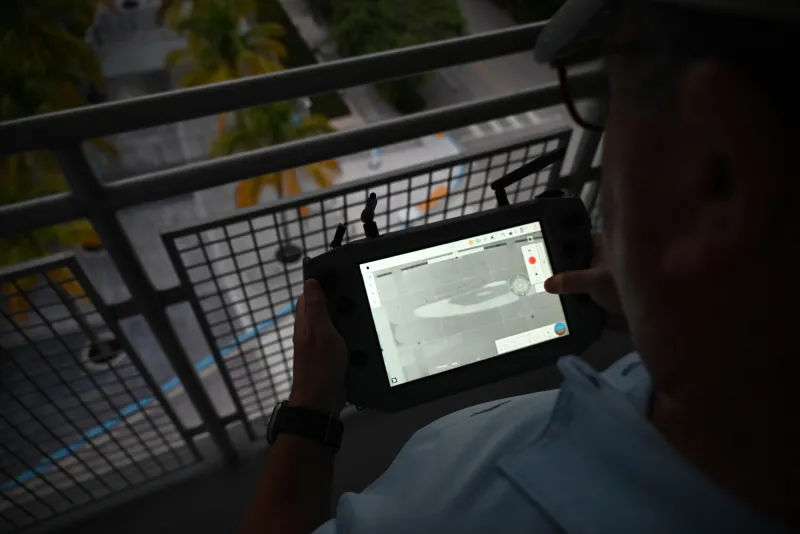A first responder looks at the screen of a Teal 2 drone GCS while observing the infield of LoanDepot Park during a night operations scenario. The display screen demonstrates the drone’s infra-red camera capabilities and enables the responder to get a clear view of the infield at night.