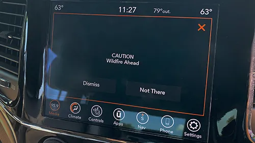 A screen displaying a Wildfire Ahead caution sign.