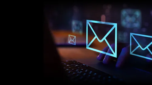 Fingers typing on a keyboard with overlayed mail icons.