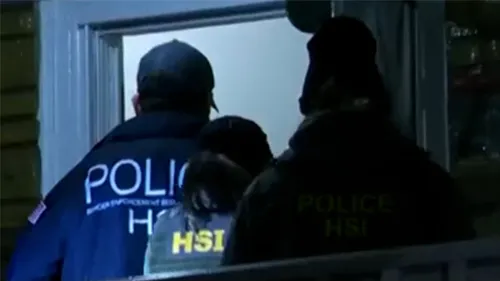 ICE HSI agents entering a residence to apprehend criminal illegal aliens.