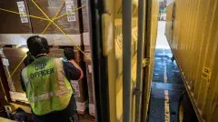 CBP agent inspecting shipping boxes