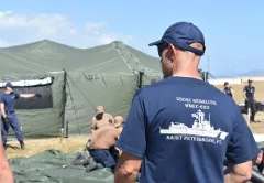 Crew members from USCGC Resolute (WMEC 620) work alongside U.S. Soldiers, Sailors, Marines and Airmen to assemble tents, cots, and pre-stage supplies during a port call at Naval Station Guantánamo Bay, Cuba, Feb. 4, 2025. The U.S. Coast Guard is assisting the U.S. Department of Defense in Operation Southern Guard in support of the U.S. Department of Homeland Security under the Seventh Coast Guard District. (U.S. Coast Guard photo by Lt. j.g. Rylee Burton) 