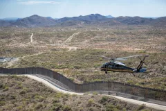 CBP Helicopter flying along border wall (photo by Jerry Glaser)