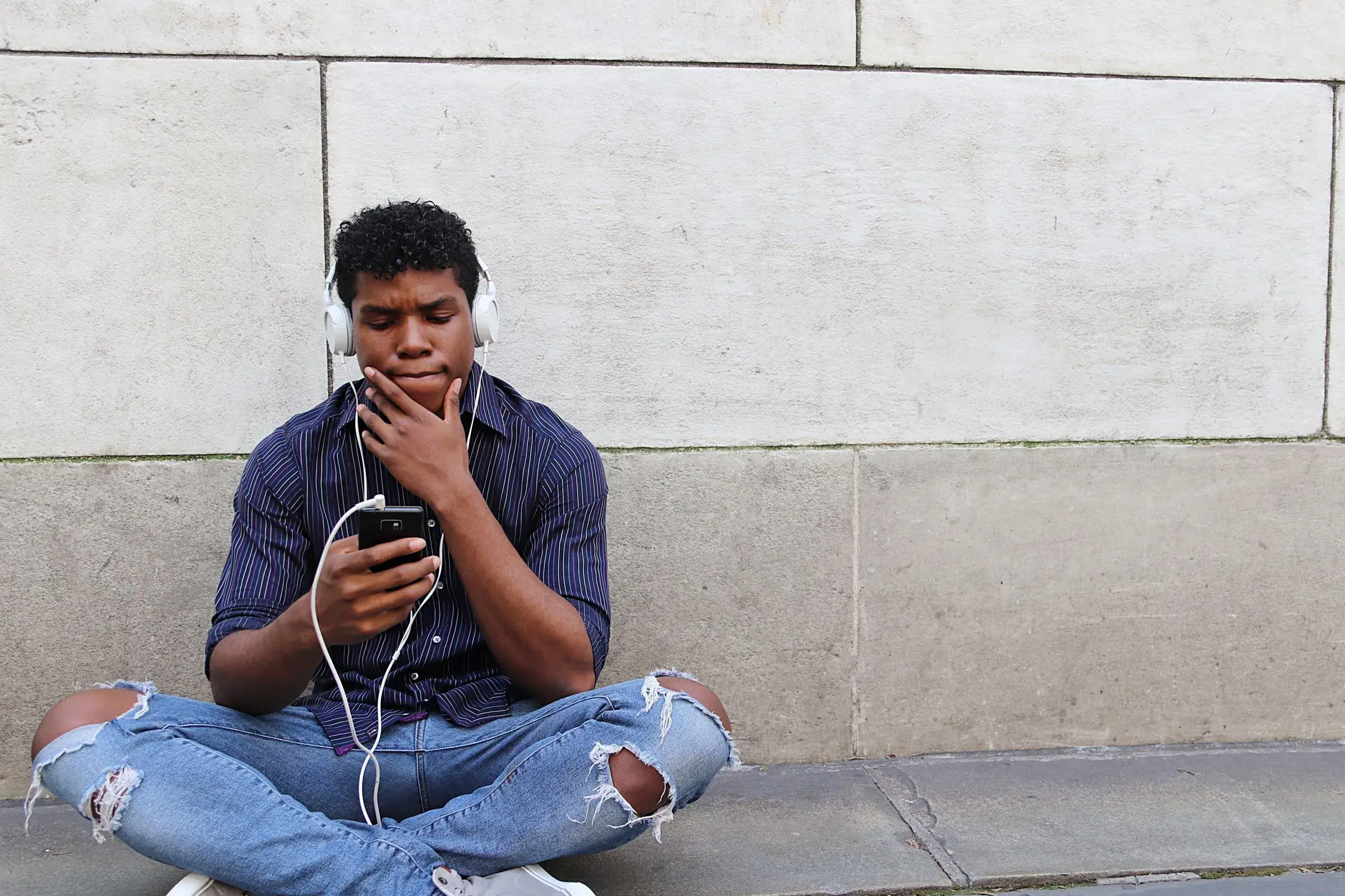 Teenager looking at his smartphone