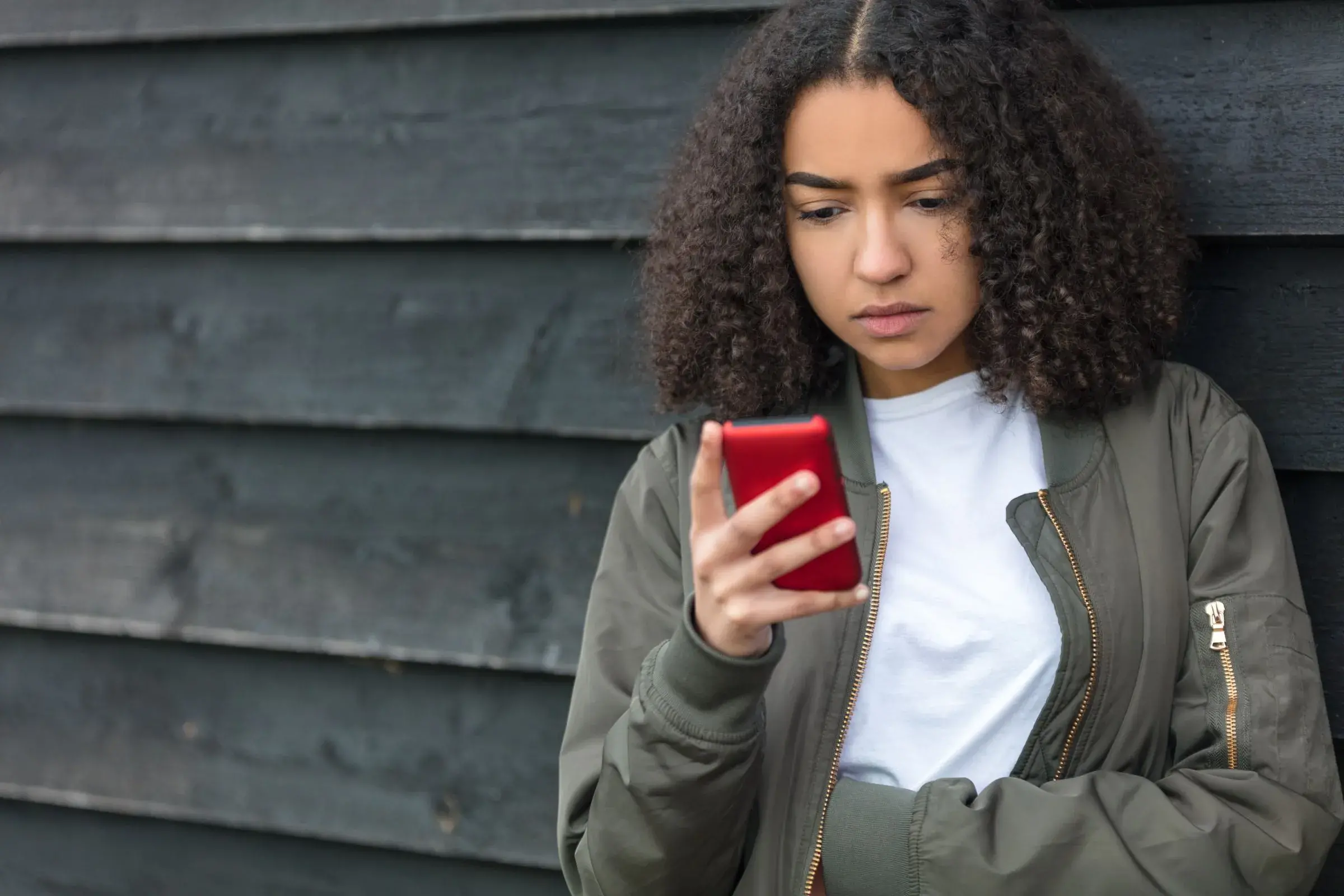 Young girl looking at her smart phone